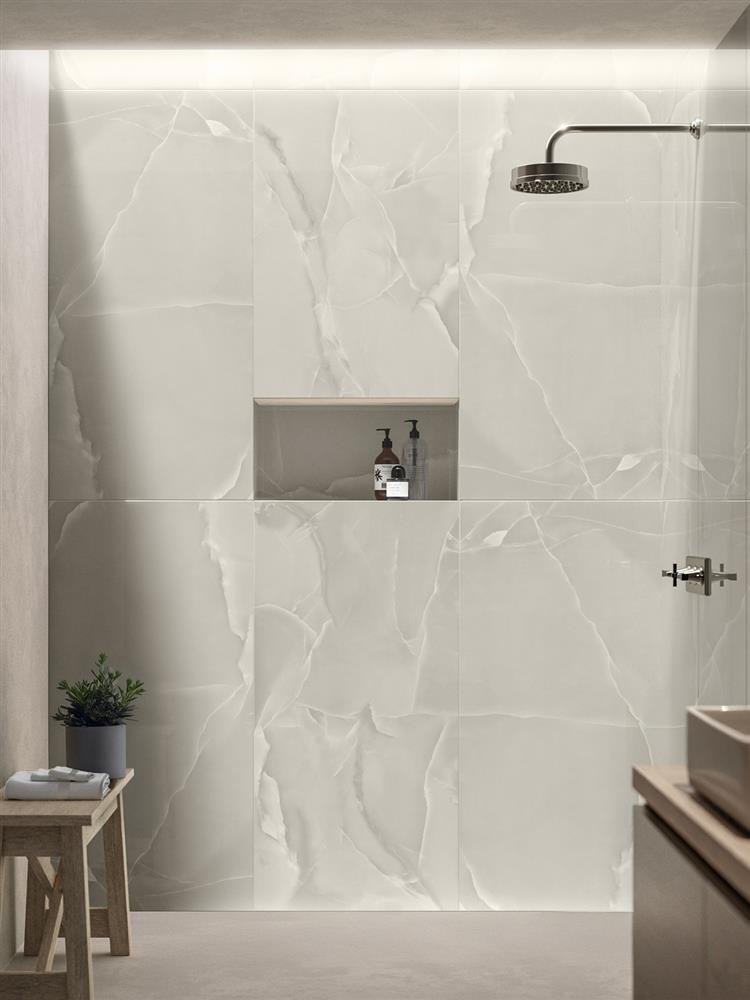 Large walk-in shower with warm grey onyx tiles